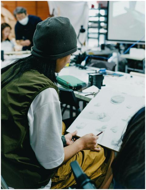 Students engaged in an art class in Shinjuku, Toky