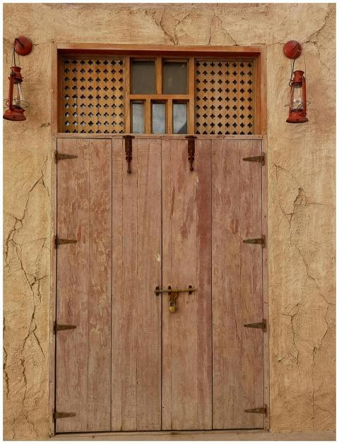Vintage wooden door with hanging lanterns on an ad