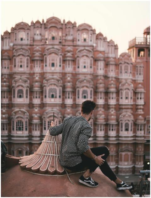 A man sitting on a rooftop overlooks the iconic Ha