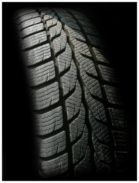 Detailed close-up image of a rubber tire showcasin