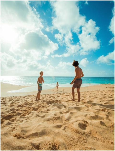 Three children enjoy a sunny day playing on Waialu