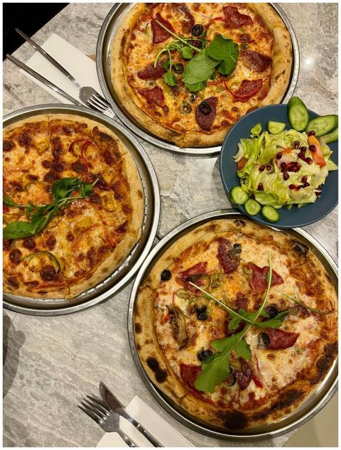 Three delicious pizzas with assorted toppings and