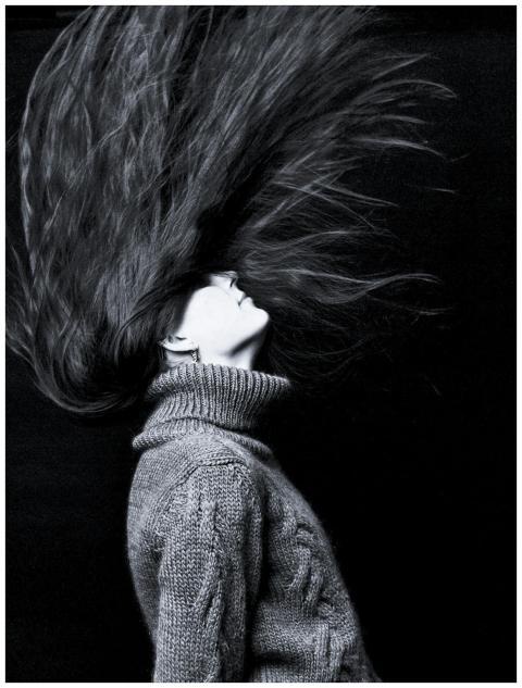 Monochrome photo capturing dramatic motion of woma