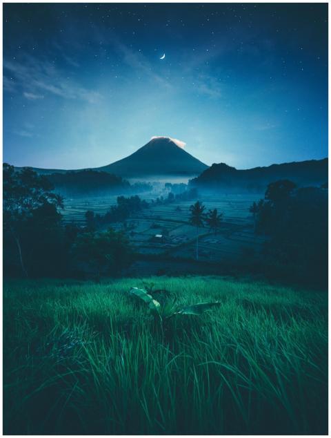 A breathtaking view of a moonlit mountain with viv