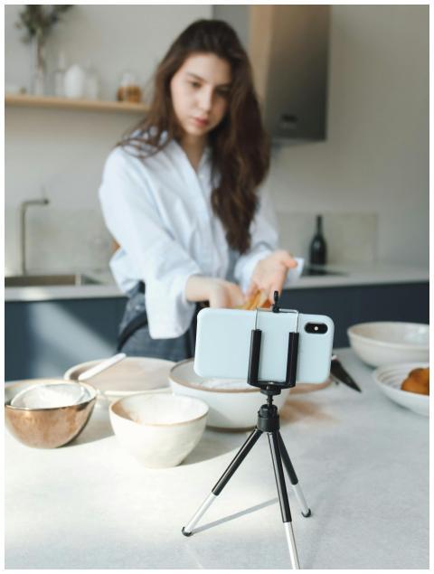 Young woman vlogging her cooking session in a mode
