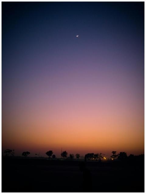 Beautiful twilight sky with a crescent moon and si