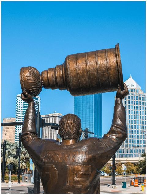 Bronze statue of a hockey player lifting the Stanl