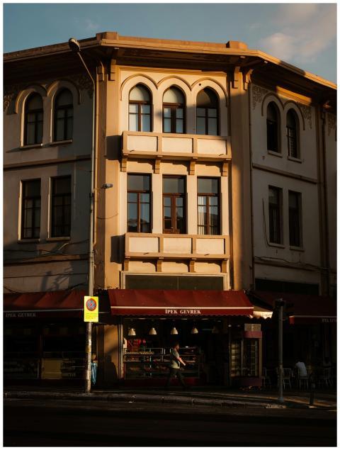 A charming old building with shops at sunset in İz
