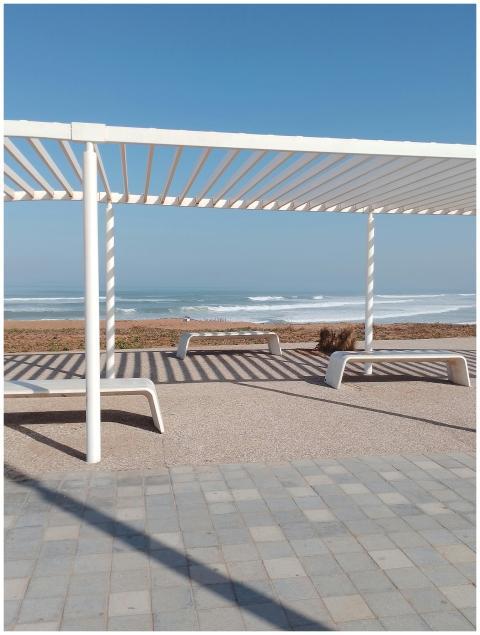 Modern pergola on Casablanca beach with ocean wave