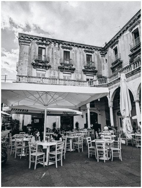 Black and white photo of an outdoor café setup in
