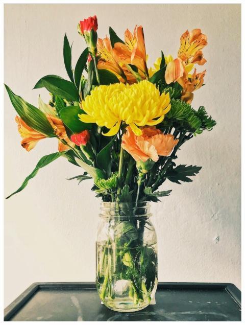 Colorful bouquet of fresh flowers in a mason jar a