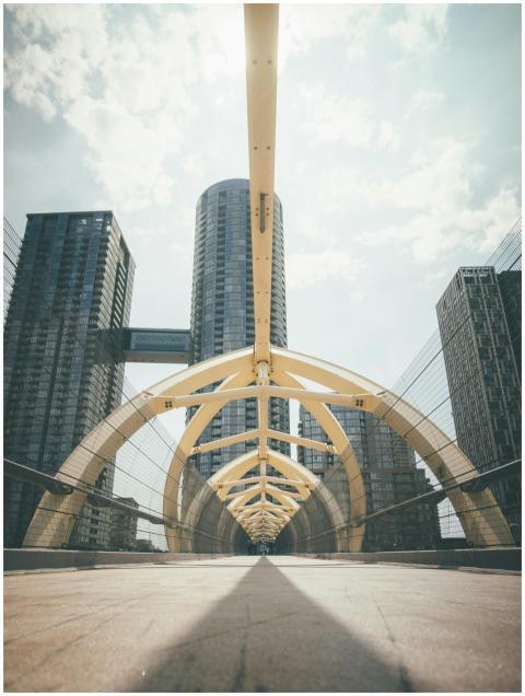 Modern urban arch bridge with towering skyscrapers