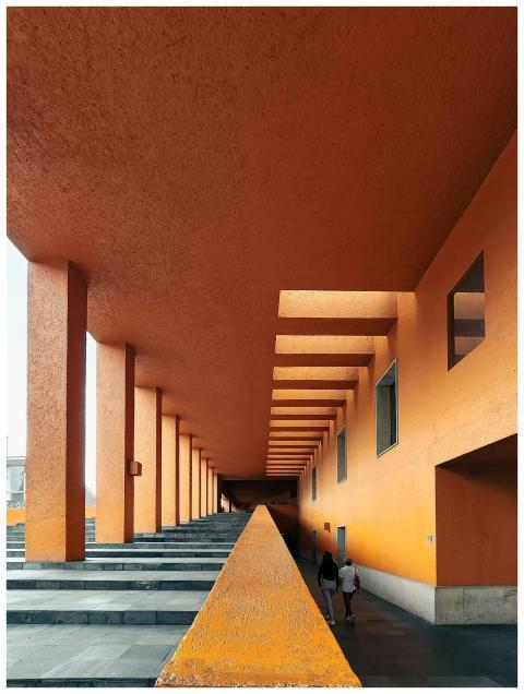 Vibrant orange modern architecture with colonnades