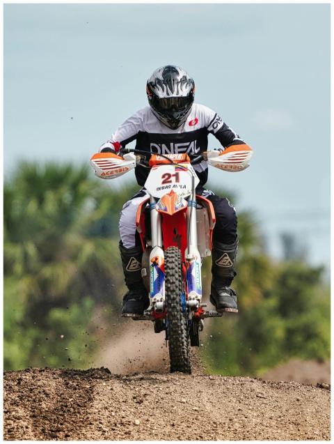 Exciting motocross race showcasing a biker jumping
