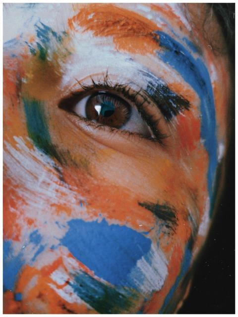 Vibrant close-up shot of a person with colorful fa