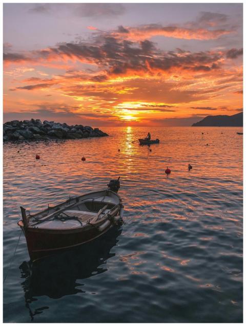 Tranquil sunset in Liguria, Italy, featuring boats