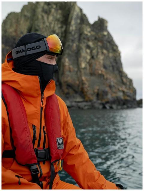 Man bundled in warm gear exploring Antarctica with
