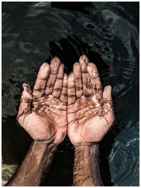From above of crop anonymous male washing hands in