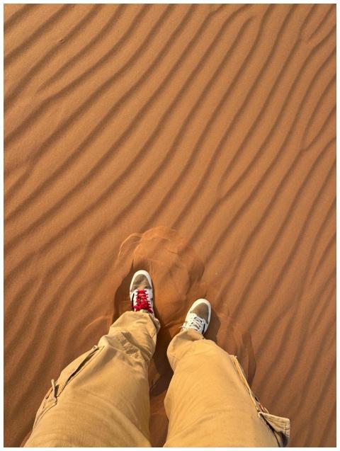 Aerial view of vibrant sneakers on textured desert
