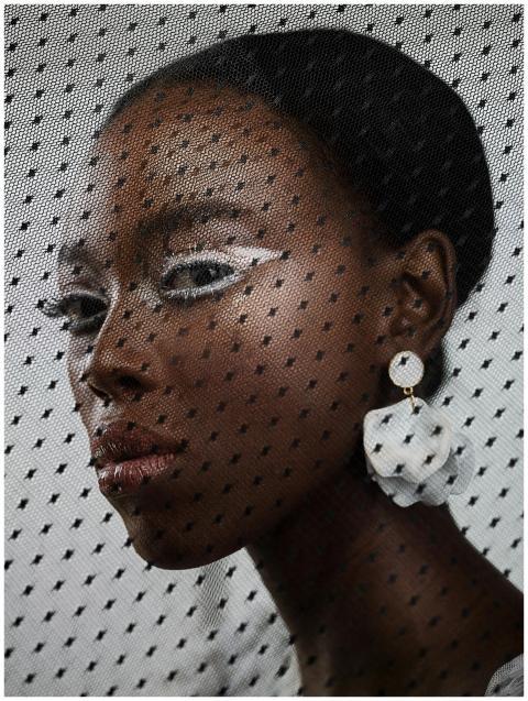 Creative fashion portrait of a woman with bold mak