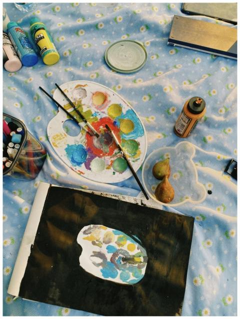 Top view of colorful paint supplies, palette, and