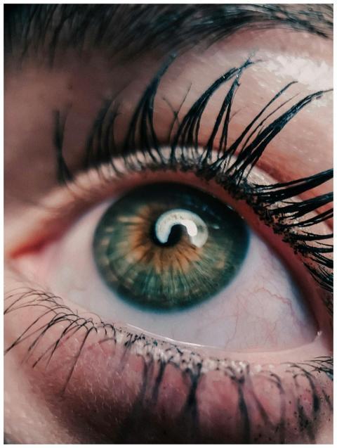 Detailed macro shot of a human eye, showcasing gre