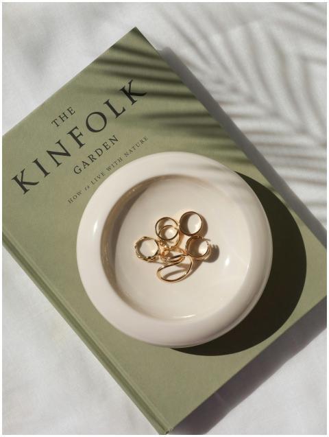 Stylish flat lay featuring gold rings on The Kinfo