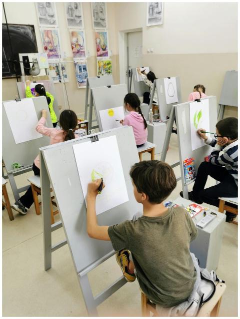 A group of children actively participating in draw