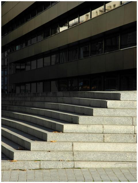 Concrete steps lead to a modern building facade, s