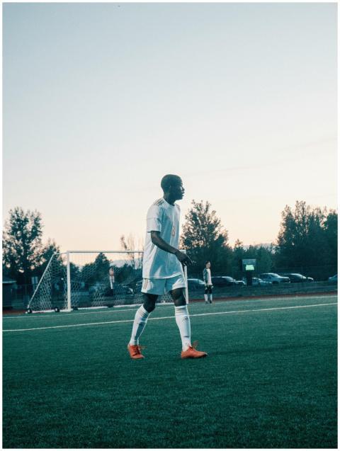 Teen soccer player in action on the field during d