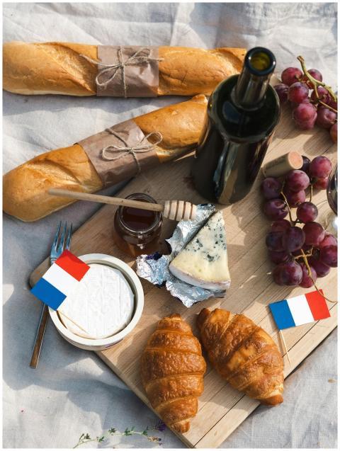 Aerial view of a French-themed picnic featuring ba