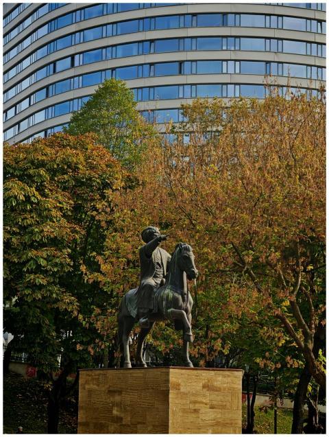 Equestrian statue in a park with autumn trees and