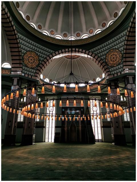 A beautiful mosque interior featuring a grand circ