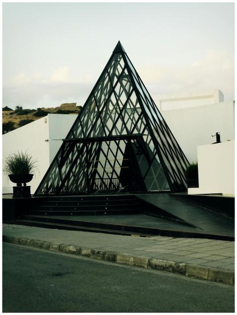 Contemporary pyramid entrance with glass facade in