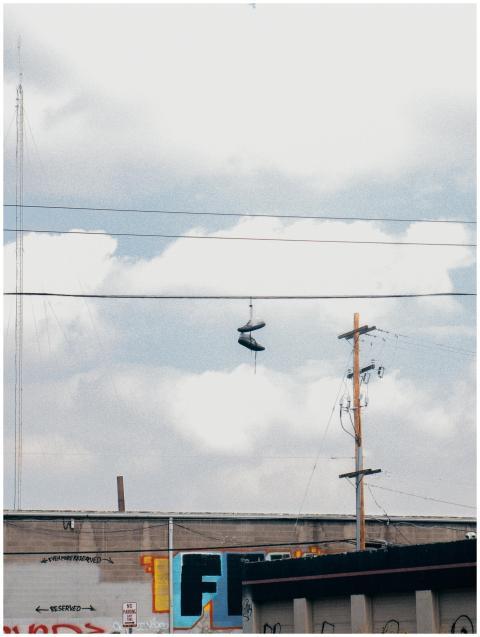 Street view of sneakers hanging on power lines aga
