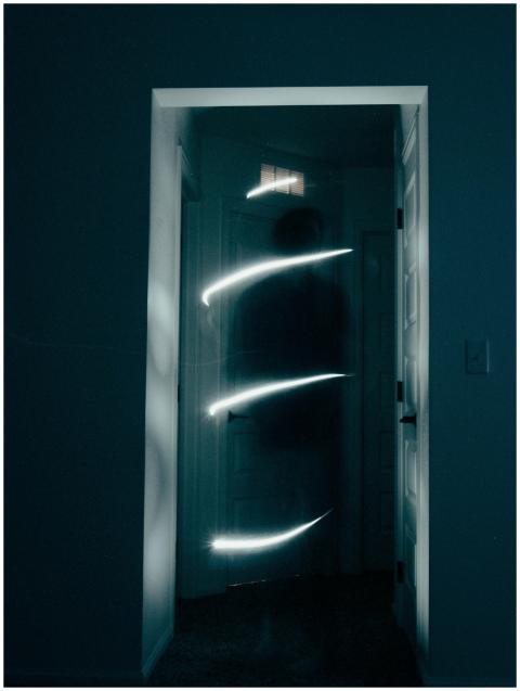 Mysterious hallway illuminated by swirling light,