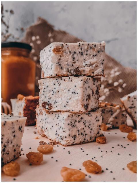 Stacked poppy seed pastries on rustic surface with