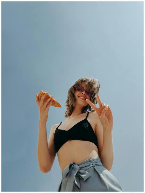 Smiling woman in swimwear posing outdoors with pea