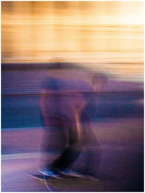 Artistic motion blur captures a skateboarder in mi