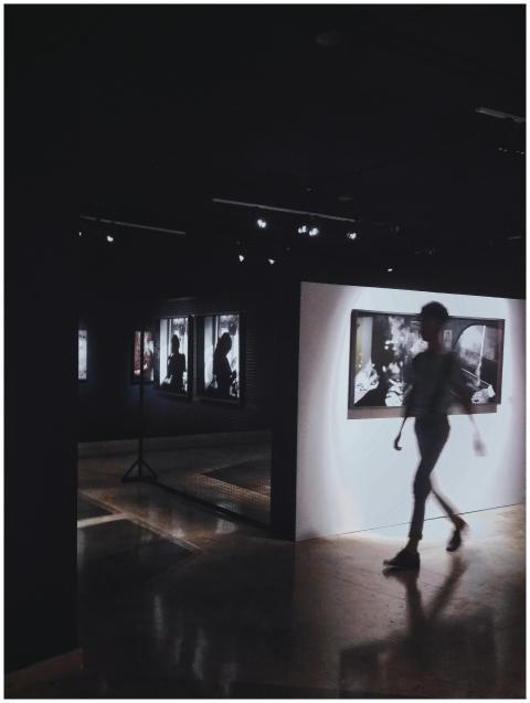 Dimly lit art gallery showcasing framed photograph