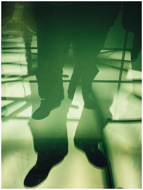 Abstract reflection of a person's lower legs and f