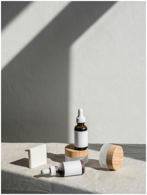 Stylish layout of skincare products with dropper b