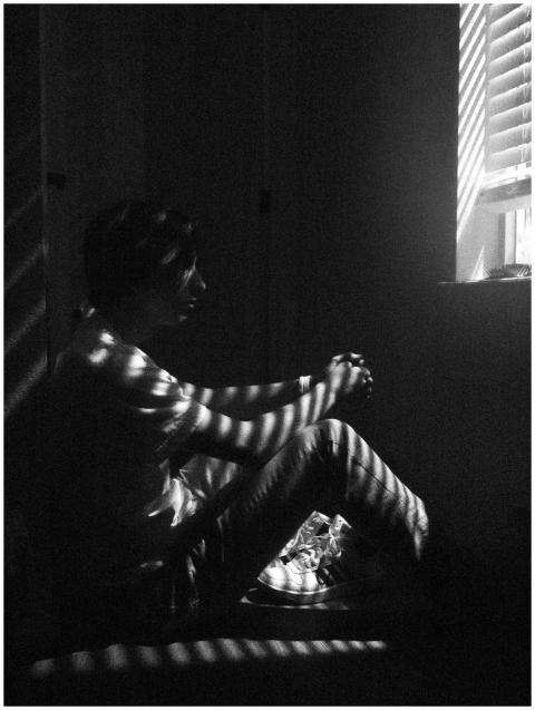 Black and white photo of a thoughtful man sitting