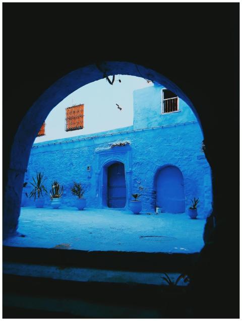 Vibrant blue alleyway in Morocco showcasing tradit