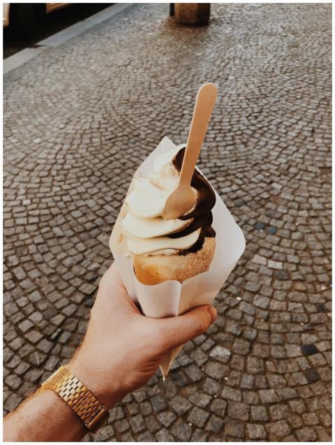 Indulge in a creamy ice cream cone with chocolate