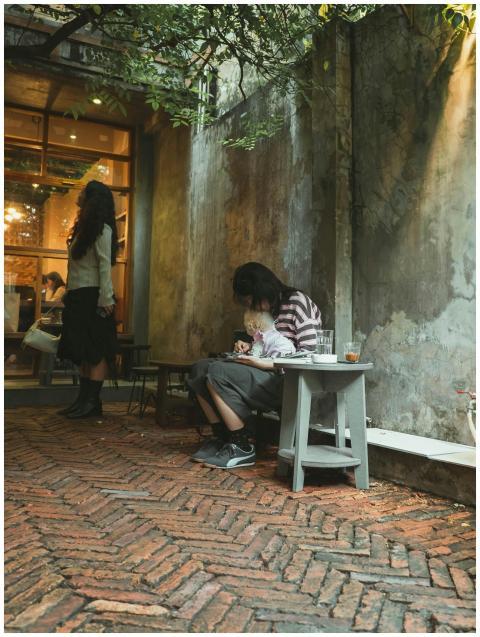 A serene outdoor café setting with people enjoying