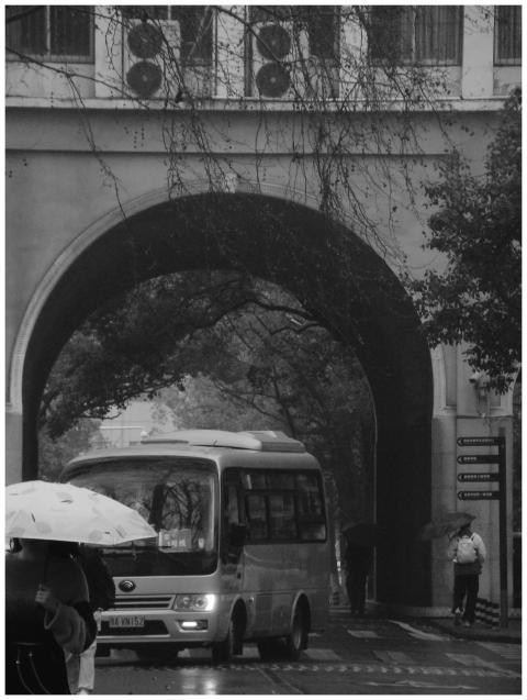 Black and white photo of a rainy urban street with