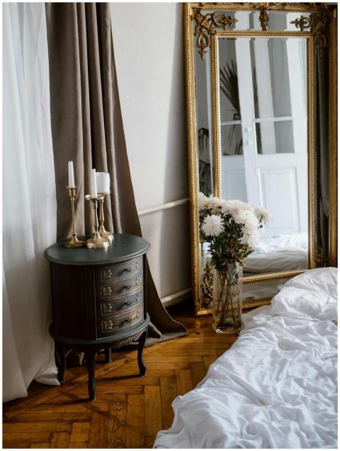 Stylish bedroom interior featuring a vintage mirro