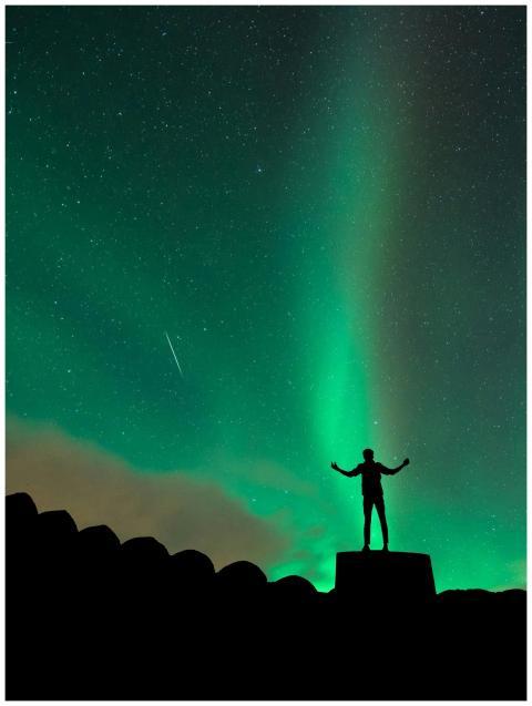 Silhouette of a person admiring the northern light