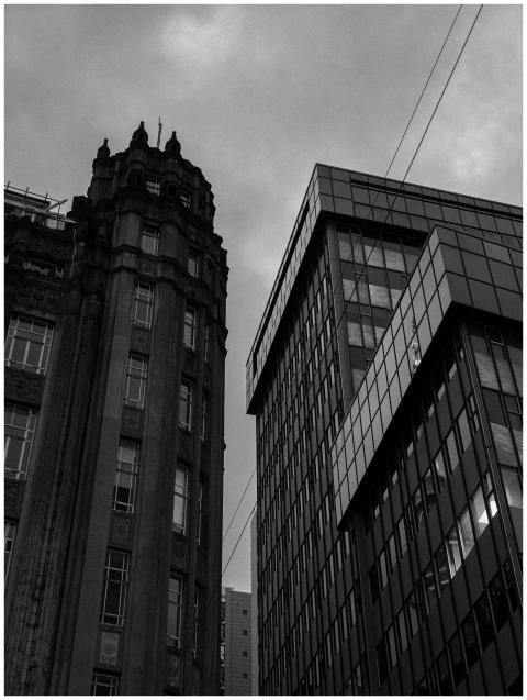 Low angle view of contrasting urban buildings in b
